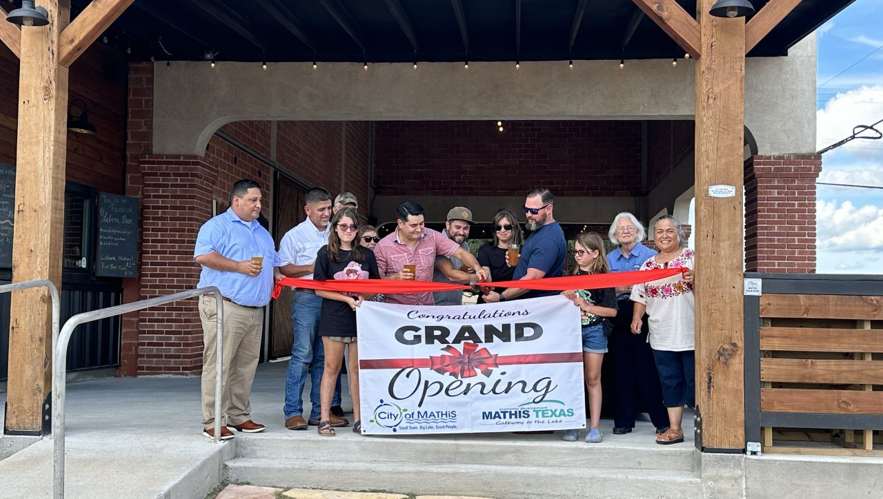 The ribbon-cutting ceremony with Mayor Ciri Villarreal, brewery founders, and Mathis EDC members.